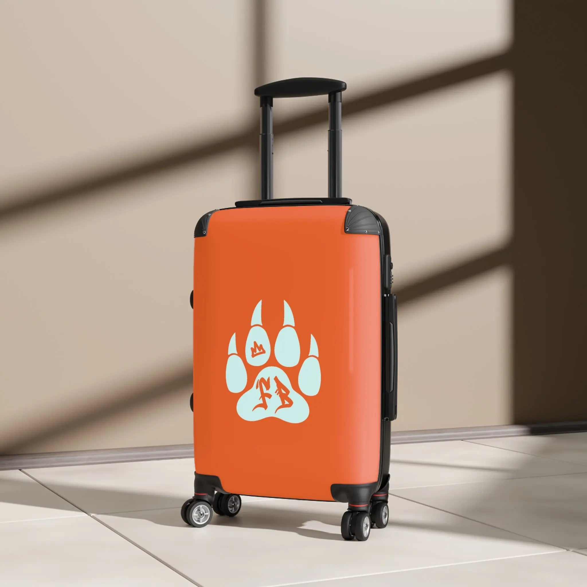 Orange hard-shell suitcase with a blue paw print design and smooth-rolling wheels.