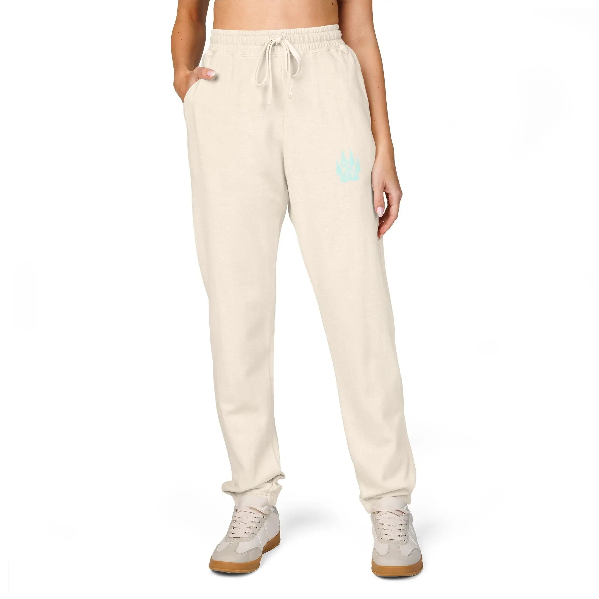 Beige women's sweatpants with pockets and turquoise logo, perfect for casual wear.