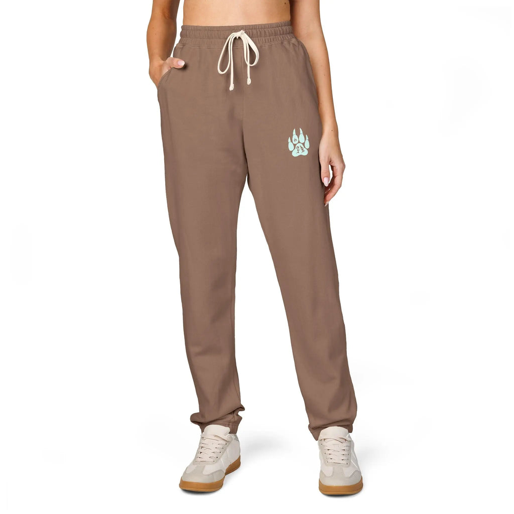 Brown women's sweatpants with pockets and a paw print design, made from soft cotton blend material.