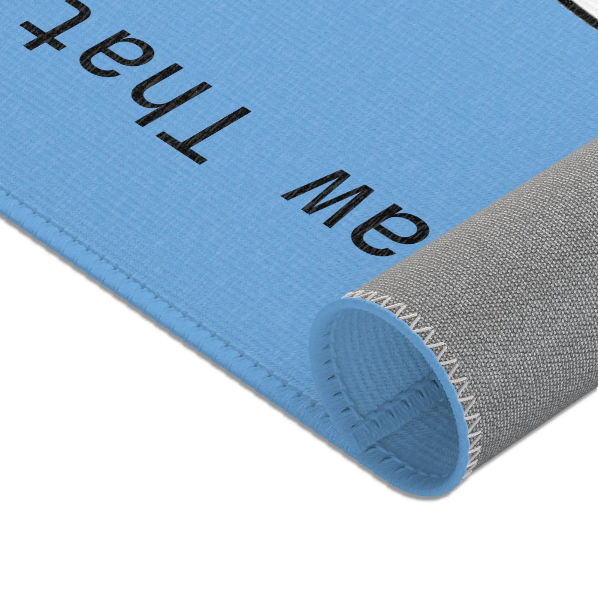 Blue textured mat with a gray edge, perfect for home decor and comfort.