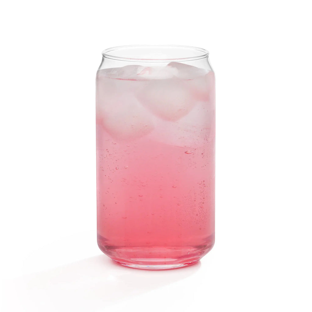 Transparent glass filled with pink soda and ice cubes, perfect for refreshing summer drinks.