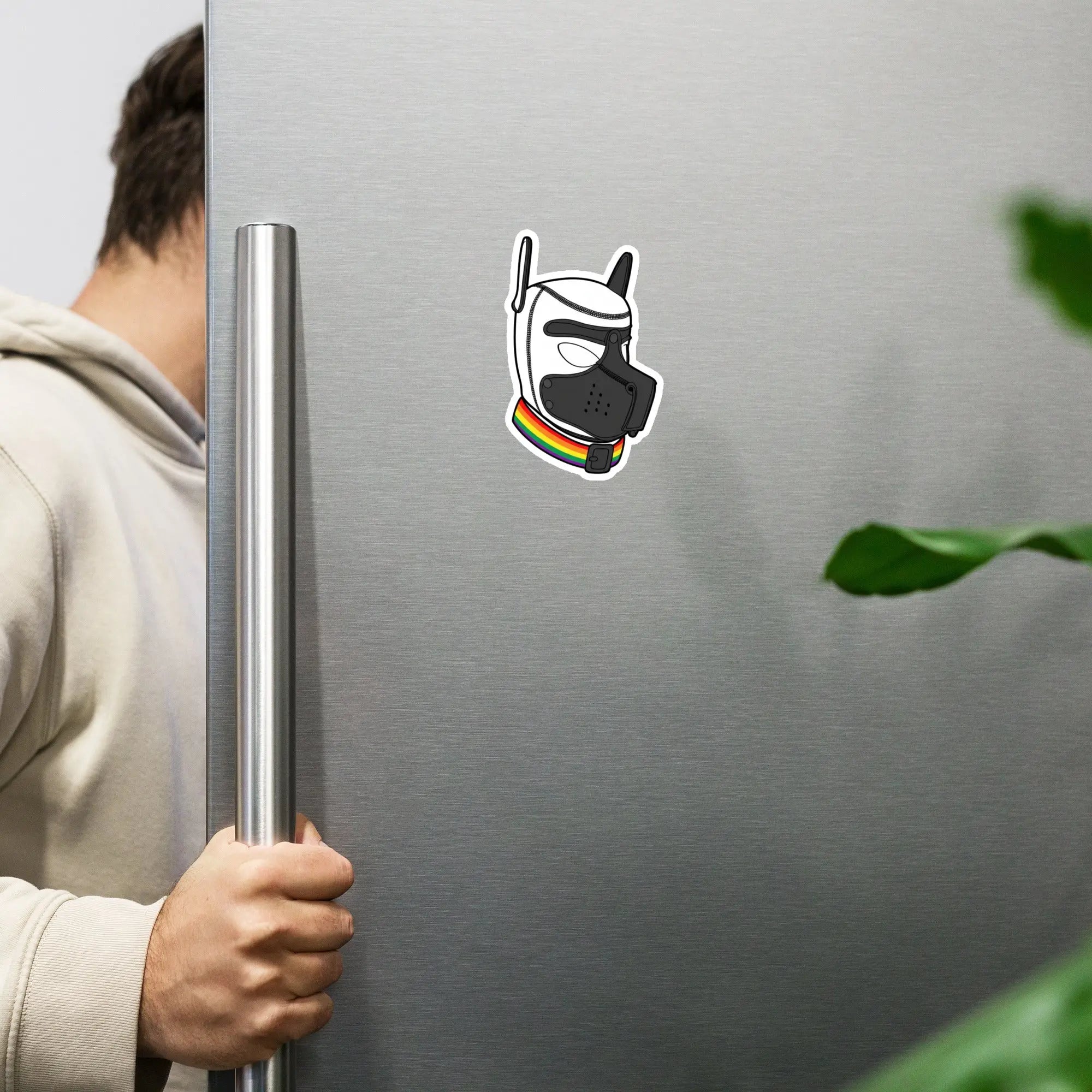 Colorful dog mask sticker with rainbow collar on a stainless steel fridge door.