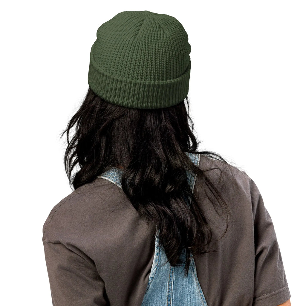 Cozy green knitted beanie hat made from soft material, perfect for winter styling.