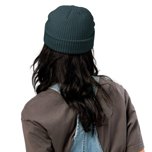 Dark teal knitted beanie hat, perfect for winter wear, stylish and warm accessory.