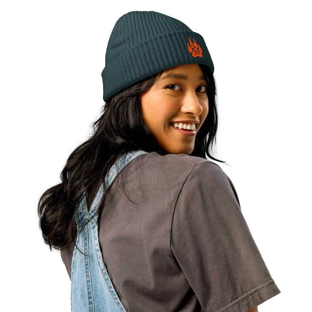 Stylish dark teal beanie with orange logo, perfect for casual wear and outdoor adventures.