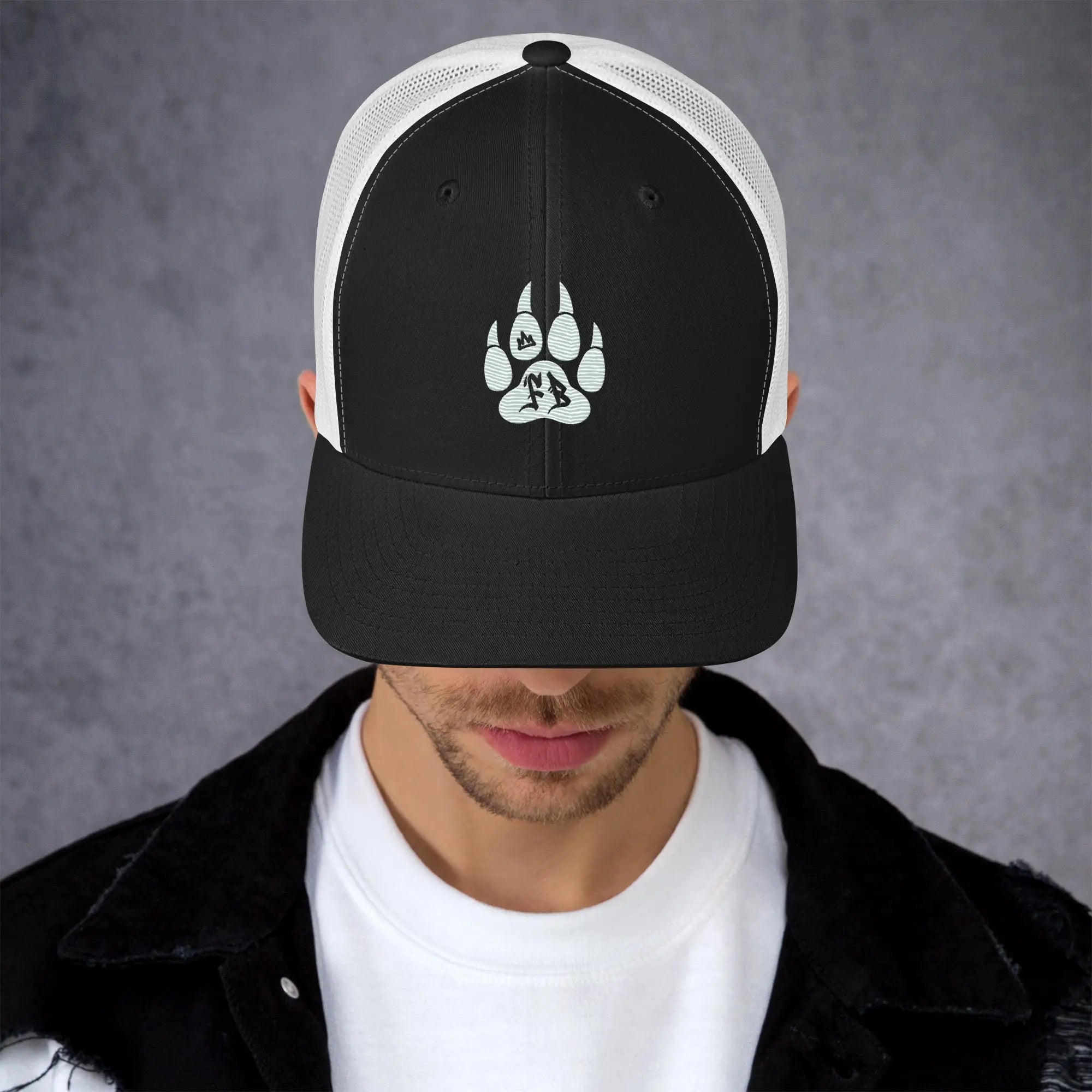 Black and white snapback cap featuring a paw print design, perfect for outdoor enthusiasts.