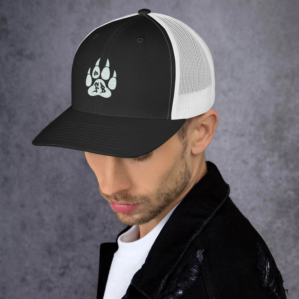 Black and white trucker hat featuring a stylish paw print design, perfect for casual outdoor wear.