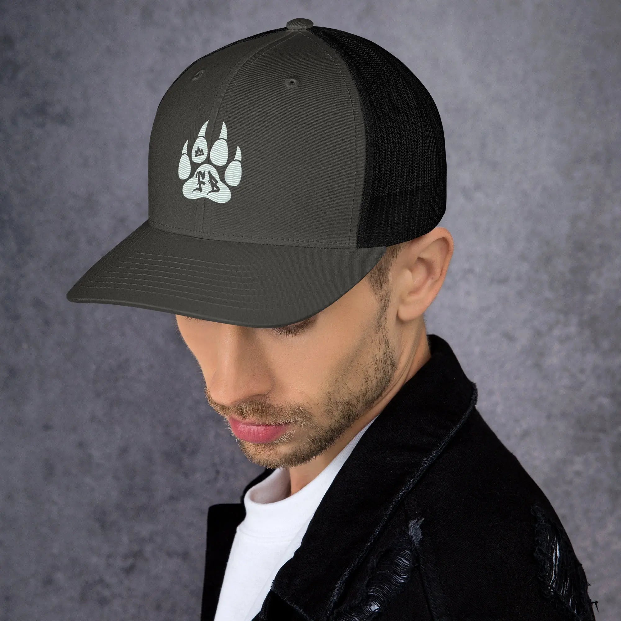 Stylish black trucker cap featuring a paw print design, perfect for outdoor enthusiasts.