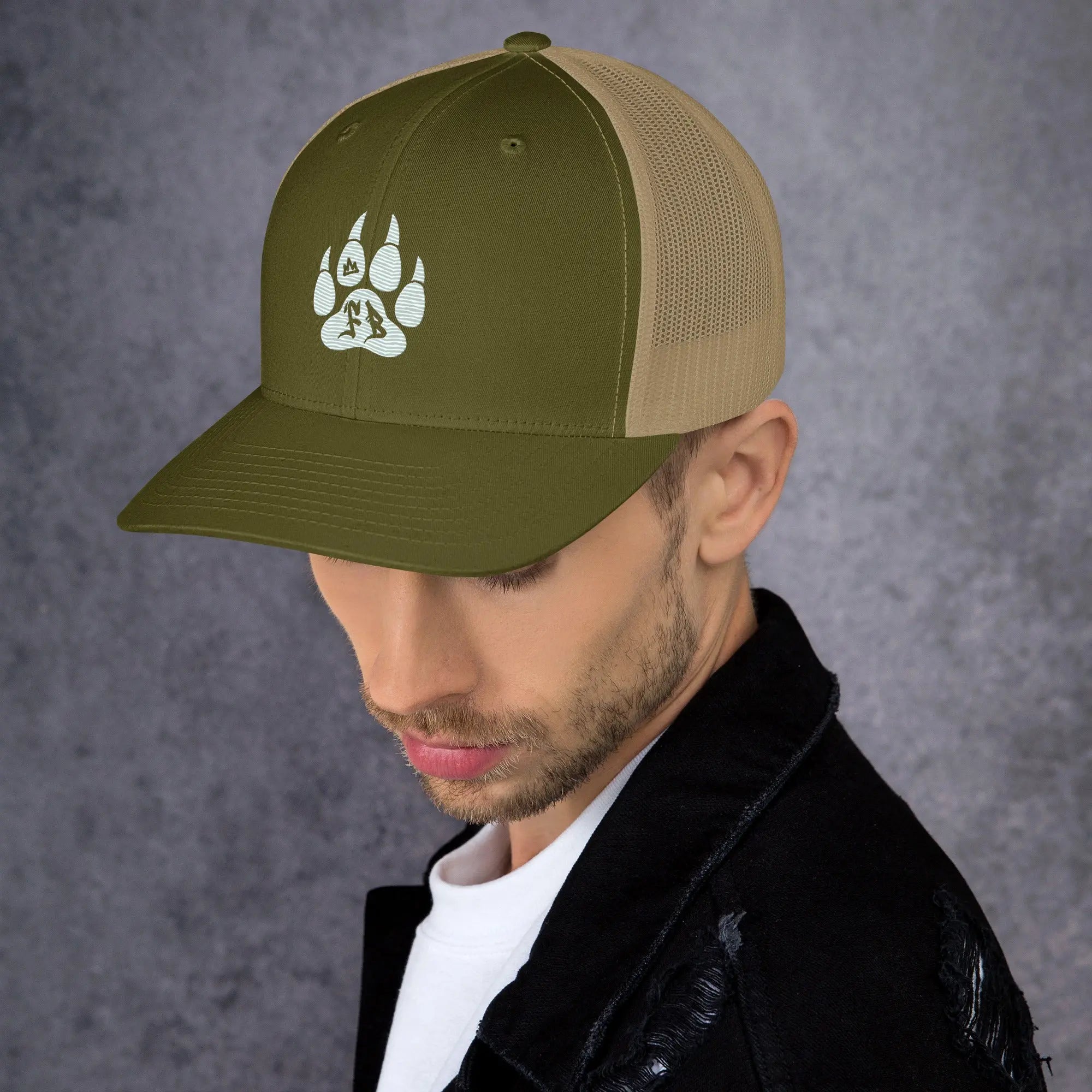 Olive green trucker hat with beige mesh, featuring a white animal paw print design.