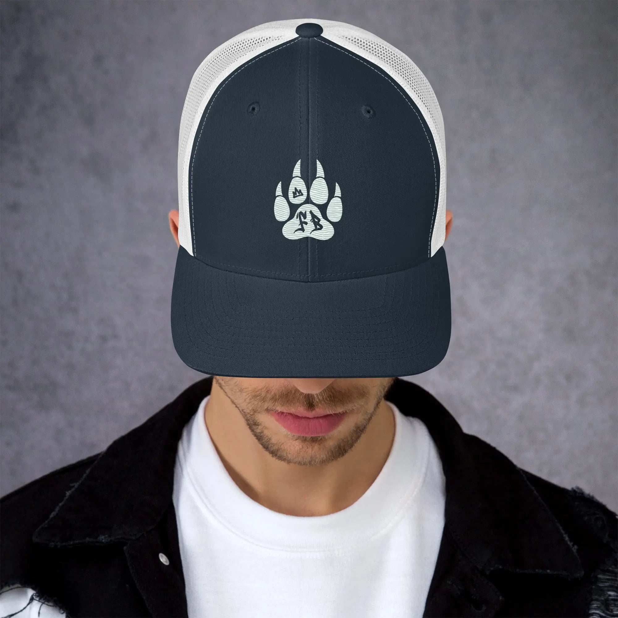 Navy blue snapback cap with white mesh and paw print design for outdoor enthusiasts.