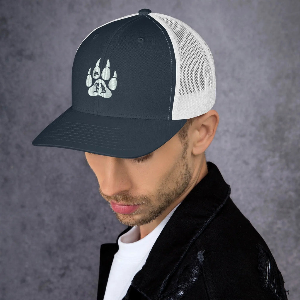 Men's navy blue trucker cap with white mesh, featuring a stylish paw print design.