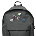 Gray backpack with colorful cartoon pins featuring playful designs and characters.