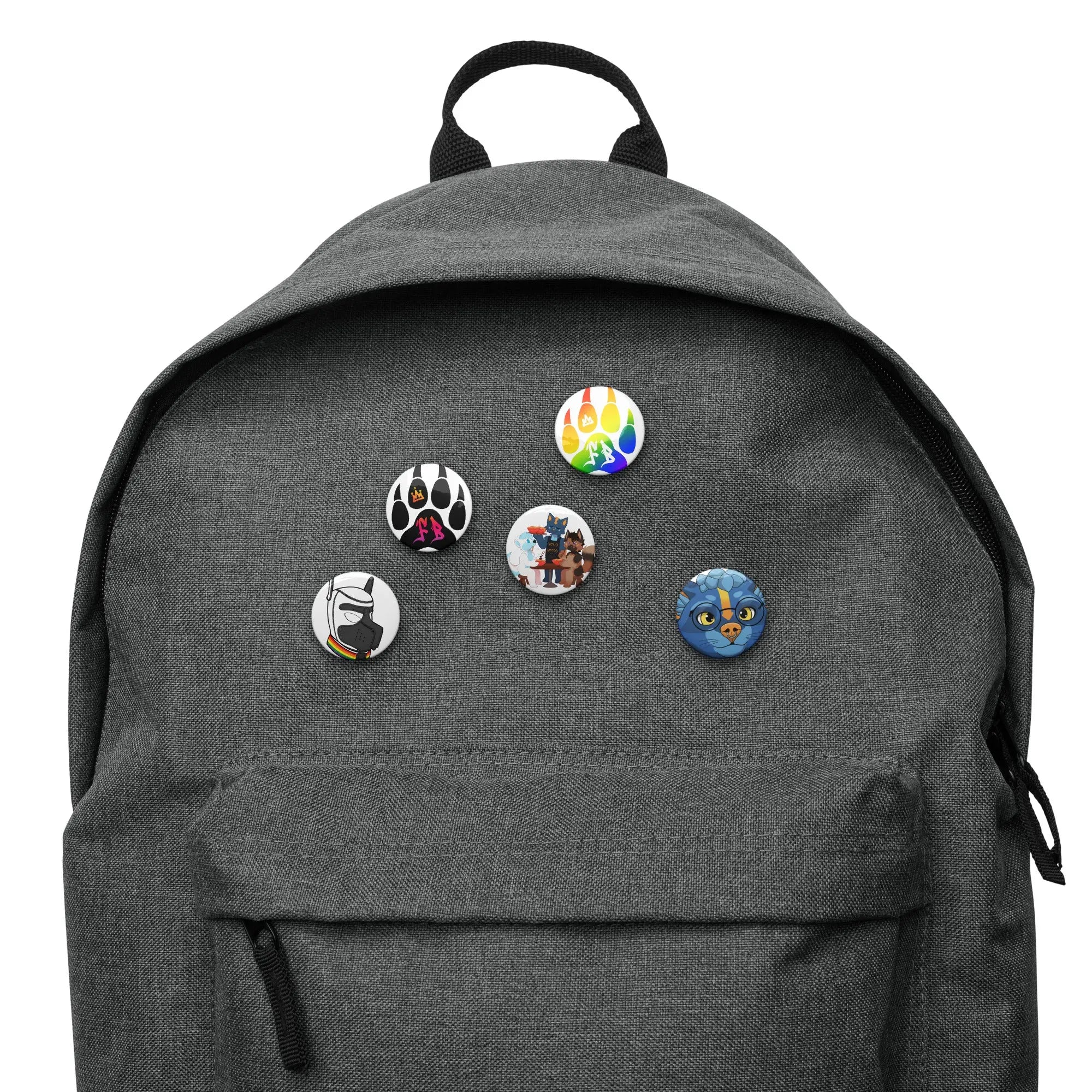 Gray backpack with colorful cartoon pins featuring playful designs and characters.