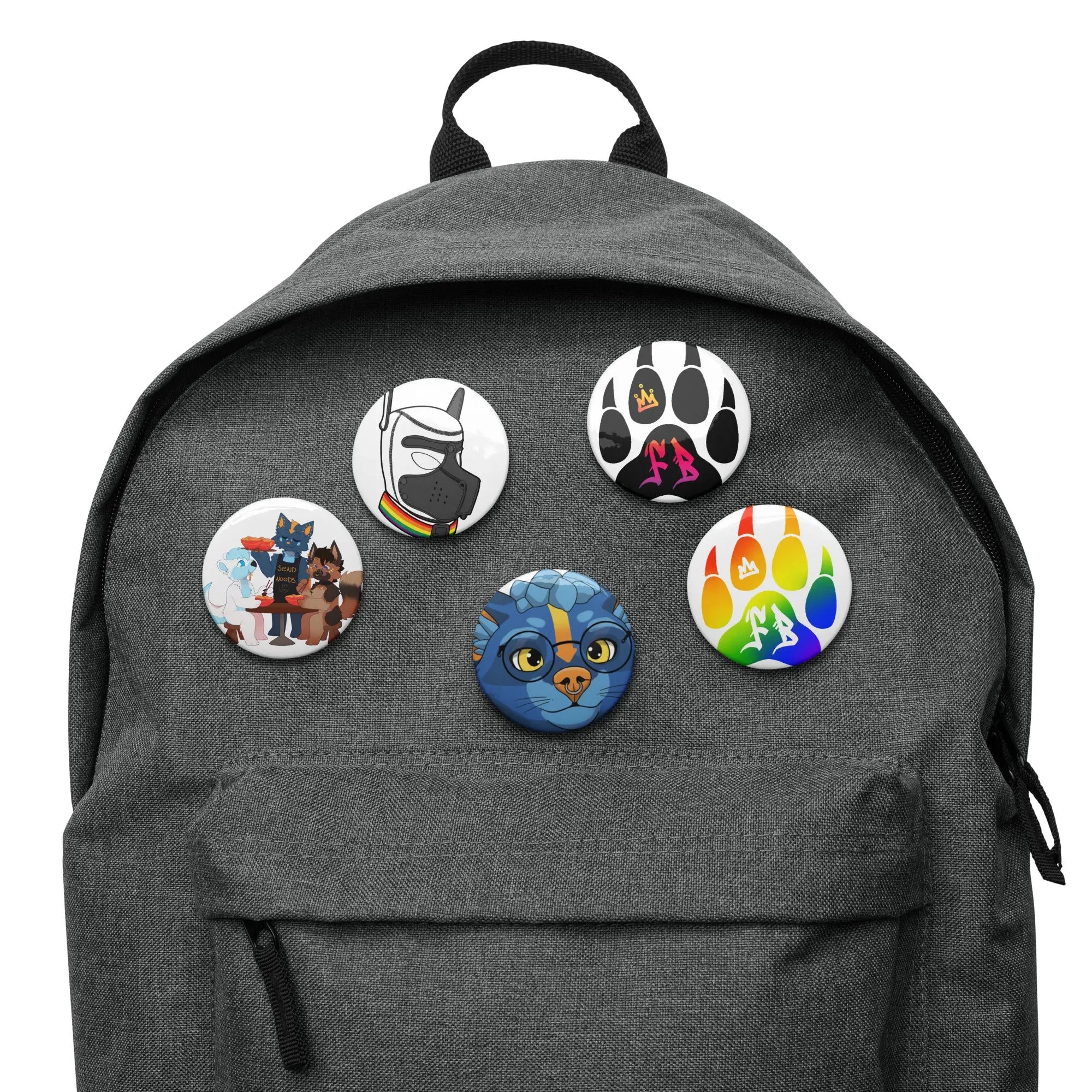 Set of colorful cat-themed buttons on a gray backpack, featuring various designs and playful graphics.