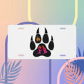 Custom white license plate with black paw print design and colorful crown, perfect for pet lovers.